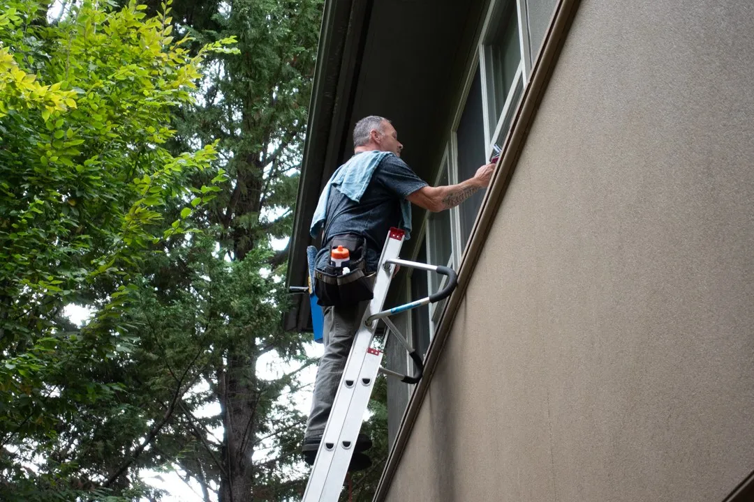 John on an extension ladder at a Seattle office building